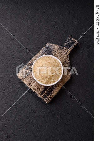 White raw rice in a ceramic bowl. Rice as an ingredient White raw rice in a ceramic bowl. Rice as an ingredient 126536778
