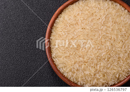 White raw rice in a ceramic bowl. Rice as an ingredient White raw rice in a ceramic bowl. Rice as an ingredient 126536797