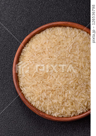 White raw rice in a ceramic bowl. Rice as an ingredient White raw rice in a ceramic bowl. Rice as an ingredient 126536798