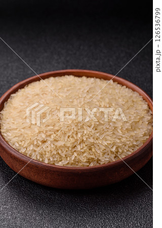 White raw rice in a ceramic bowl. Rice as an ingredient White raw rice in a ceramic bowl. Rice as an ingredient 126536799