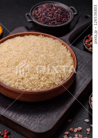 White raw rice in a ceramic bowl. Rice as an ingredient 126536803