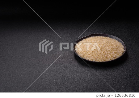 White raw rice in a ceramic bowl. Rice as an ingredient 126536810