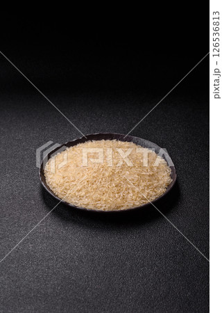 White raw rice in a ceramic bowl. Rice as an ingredient White raw rice in a ceramic bowl. Rice as an ingredient 126536813