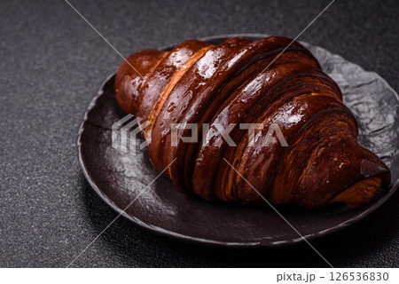 Sweet fresh crispy croissant with chocolate filling 126536830