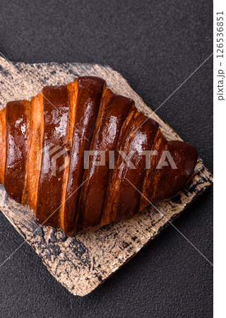 Sweet fresh crispy croissant with chocolate filling Sweet fresh crispy croissant with chocolate filling 126536851