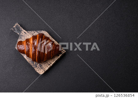 Sweet fresh crispy croissant with chocolate filling 126536854