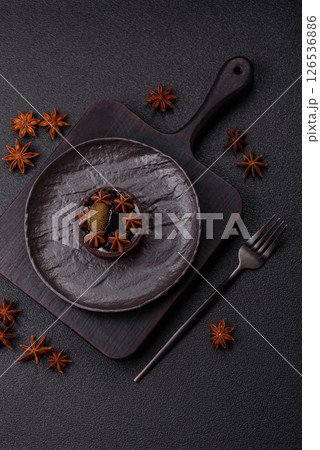 Sweet round tart with chocolate coating and nut filling Sweet round tart with chocolate coating and nut filling 126536886