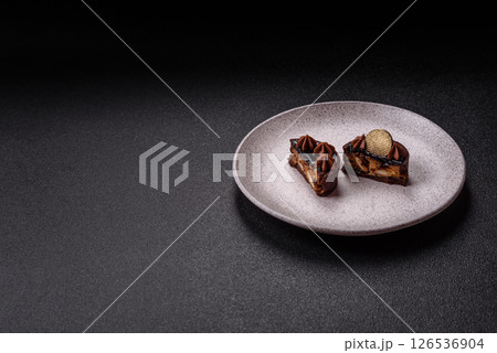 Sweet round tart with chocolate coating and nut filling 126536904