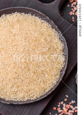 White raw rice in a ceramic bowl. Rice as an ingredient White raw rice in a ceramic bowl. Rice as an ingredient 126536920