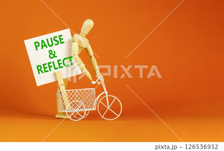 Pause and reflect symbol. Concept words Pause and reflect on beautiful white paper on clothespin. Beautiful orange background. Business motivational lifestyle pause and reflect concept. Copy space. 126536932