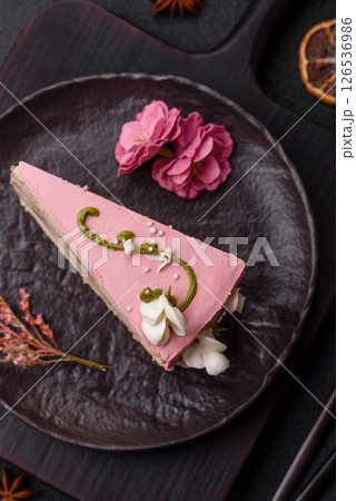 A piece of pink layered cake with strawberry flavor A piece of pink layered cake with strawberry flavor 126536986