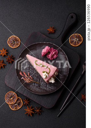 A piece of pink layered cake with strawberry flavor 126536990