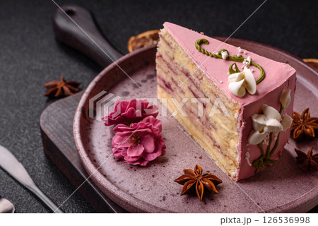 A piece of pink layered cake with strawberry flavor A piece of pink layered cake with strawberry flavor 126536998