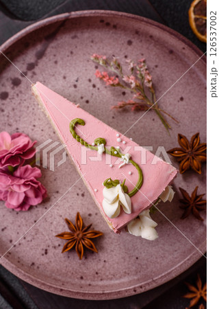 A piece of pink layered cake with strawberry flavor 126537002