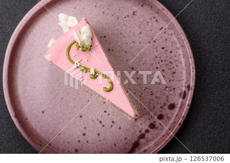 A piece of pink layered cake with strawberry flavor 126537006