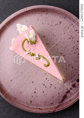 A piece of pink layered cake with strawberry flavor 126537008
