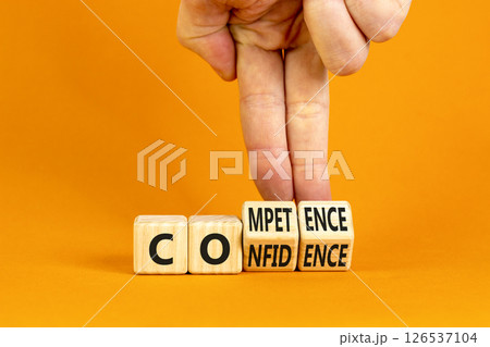 Competence and confidence symbol. Concept word Competence Confidence on wooden cubes. Businessman hand. Beautiful orange table orange background. Business competence confidence concept. Copy space. Competence and confidence symbol. Concept word Competence Confidence on wooden cubes. Businessman hand. Beautiful orange table orange background. Business competence confidence concept. Copy space. 126537104
