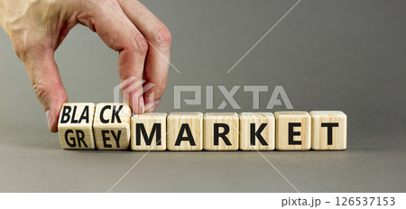Black or grey market symbol. Concept words Black market or Grey market on beautiful wooden blocks. Beautiful grey background. Businessman hand. Business black or grey market concept. Copy space. 126537153