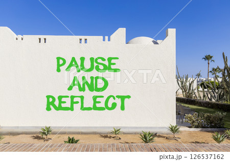 Pause and reflect symbol. Concept words Pause and reflect on beautiful white wall. Beautiful white wall blue sky background. Business motivational lifestyle pause and reflect concept. Copy space. 126537162