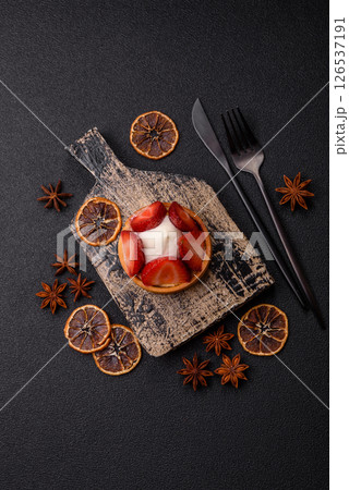 Round sweet tart with strawberry pieces and cream Round sweet tart with strawberry pieces and cream 126537191