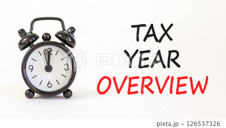 Tax year overview symbol. Concept words Tax year overview on beautiful white paper. Beautiful white background. Black alarm clock. Business tax year overview concept. Copy space. 126537326