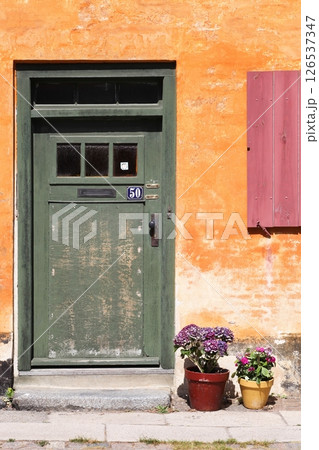 Old orange house of Nyboder district in Copenhagen, Denmark	 126537347