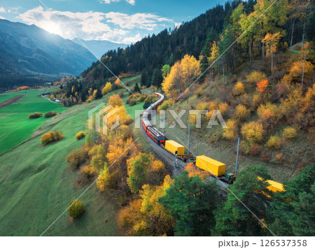 Aerial view of modern red train with yellow freight wagons Aerial view of modern red train with yellow freight wagons 126537358