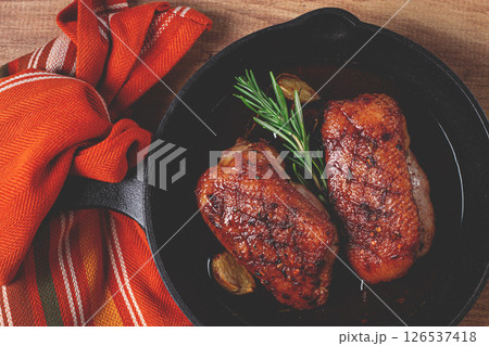 roast duck breast, in a frying pan, with spices and herbs, close-up, no people, 126537418