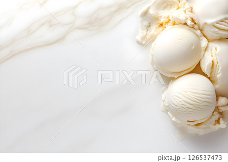 Minimalist composition of vanilla ice cream scoops on white marble background. The creamy white ice cream spheres are positioned in the corner of the frame, creating an elegant negative space design.  126537473