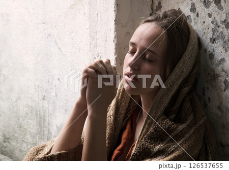 Poor young girl prayint to God Poor young girl prayint to God 126537655