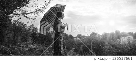 Young girl with big umbrella Young girl with big umbrella 126537661