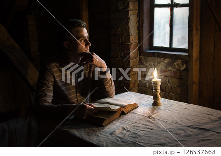 Man at the table reading book Man at the table reading book 126537668