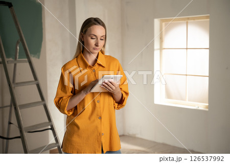 Architect using digital tablet during apartment renovation project 126537992