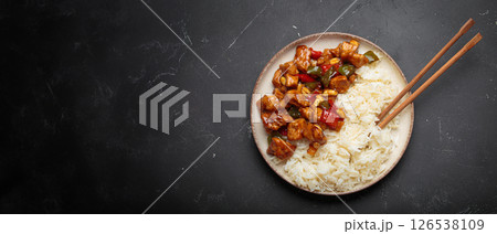 Kung pao chicken with peanuts and rice on a plate top view, traditional Chinese cuisine 126538109