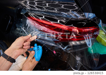 Applying a Protective Film on the Surface of Your Car for Enhanced Durability and Shine Applying a Protective Film on the Surface of Your Car for Enhanced Durability and Shine 126538415
