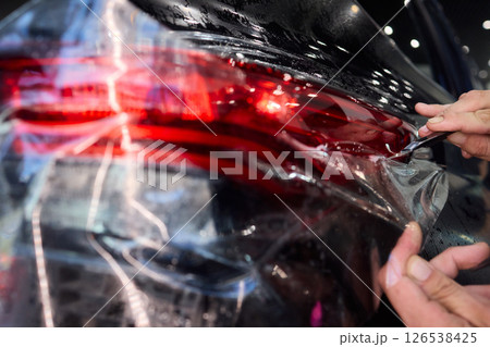 Applying a Protective Film on the Surface of Your Car for Enhanced Durability and Shine Applying a Protective Film on the Surface of Your Car for Enhanced Durability and Shine 126538425
