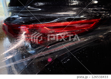 Applying a Protective Film on the Surface of Your Car for Enhanced Durability and Shine Applying a Protective Film on the Surface of Your Car for Enhanced Durability and Shine 126538433