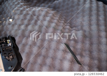 Hands Skillfully Engaged in the Construction of an Acoustic Foam Structure and Installation Hands Skillfully Engaged in the Construction of an Acoustic Foam Structure and Installation 126538462