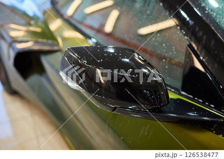 A luxury car is undergoing a foam wash treatment to enhance its appearance and shine 126538477
