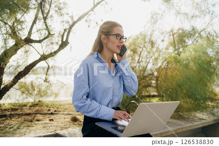 A Young Professional Engaging in Work Remotely While Surrounded by Beautiful Nature 126538830