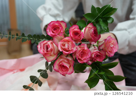 girl makes a bouquet of pink roses girl makes a bouquet of pink roses 126541210
