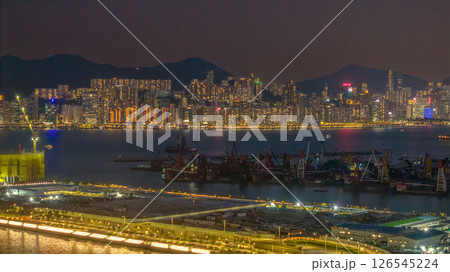 May 12 2025 Vibrant Urban Skyline at Night Reflecting on Calm Waterfront 126545224
