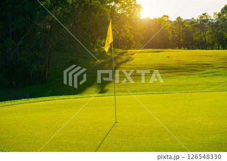 Beautiful golf course in a sunny day. Background evening golf course has sunlight shining down. Beautiful golf course in a sunny day. Background evening golf course has sunlight shining down. 126548330