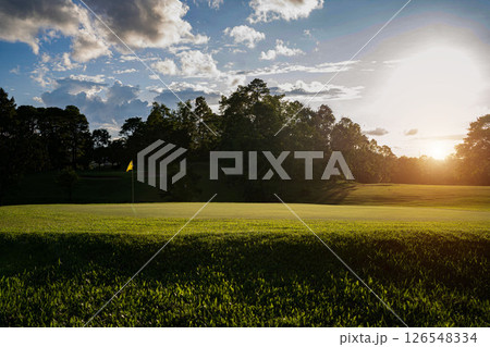 Beautiful golf course in a sunny day. Background evening golf course has sunlight shining down. 126548334