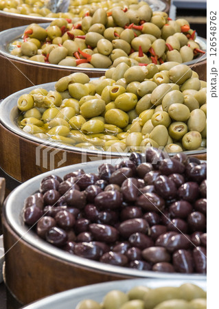 Fresh olives in barrels on street market or in grocery shop. Snack containing vitamins Fresh olives in barrels on street market or in grocery shop. Snack containing vitamins 126548762
