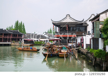 Chinese waterman paddle boat along Zhujiajiao water town 126550260