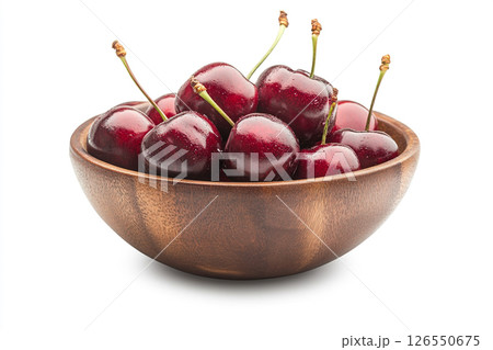 A wooden bowl filled with fresh, dark red cherries, each covered in water droplets, creating a visually appealing and appetizing image. 126550675