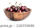 A wooden bowl filled with fresh, dark red cherries, each covered in water droplets, creating a visually appealing and appetizing image. 126550686