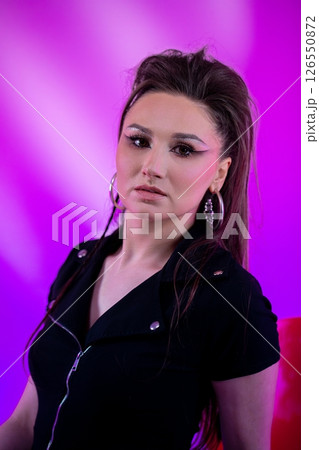 A Stylish Portrait of a Young Woman Set Against a Vibrant and Colorful Background A Stylish Portrait of a Young Woman Set Against a Vibrant and Colorful Background 126550872
