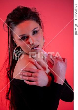 A Fashion Model Pose Captured in Dramatic Lighting for a Striking Visual Experience A Fashion Model Pose Captured in Dramatic Lighting for a Striking Visual Experience 126550974